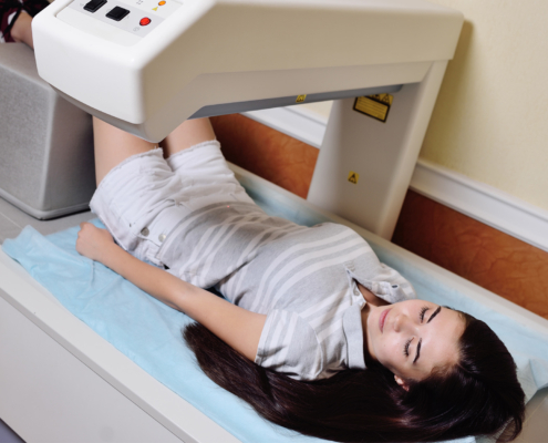 girl on examination in a modern clinic by densitometry